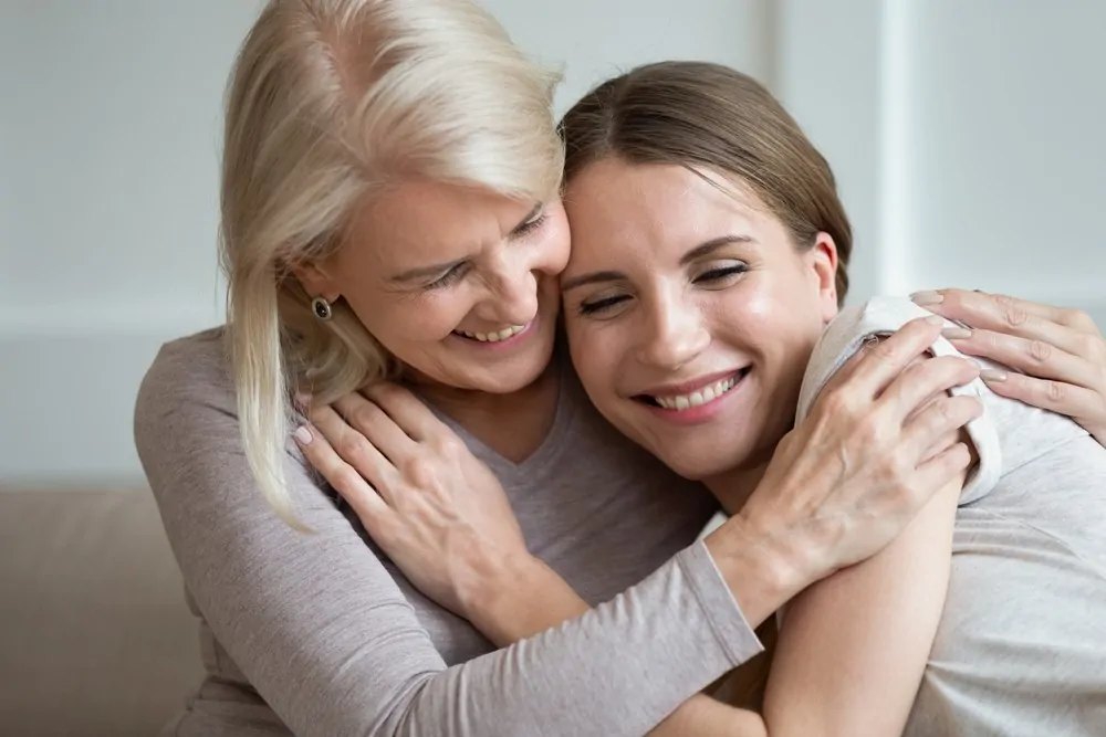 Mother and daughter hugging