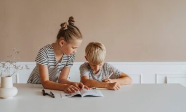 Girl helping boy with homework