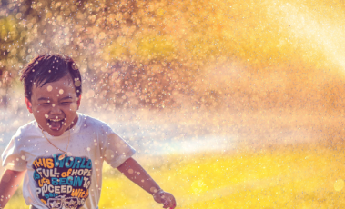 Child being sprayed with water