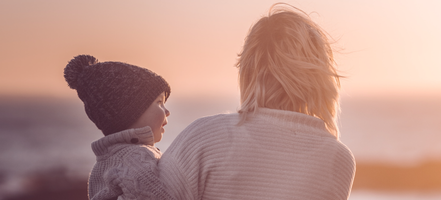 Woman carrying child