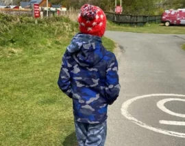 Child walking down road to beach