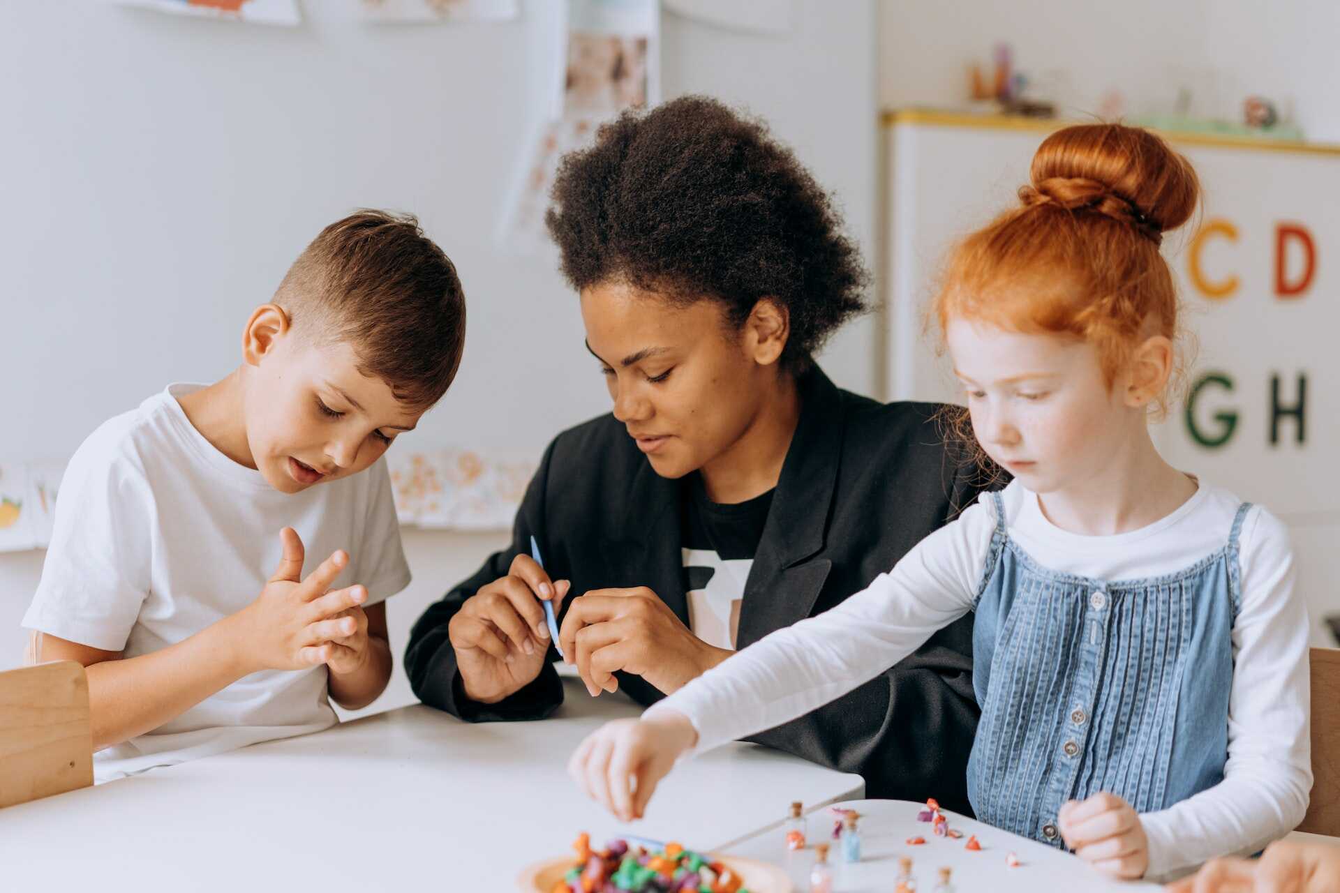 Adult and children playing with PlayDoh