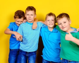 Boys posing in front of yellow background