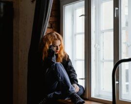 Girl sat on windowsill