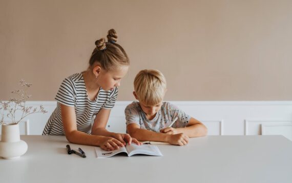 Girl helping boy with homework